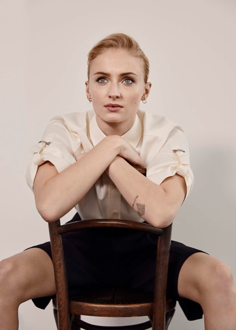 Sitting in a chair, Sophie Turner models Givenchy shirt and PushButton shorts