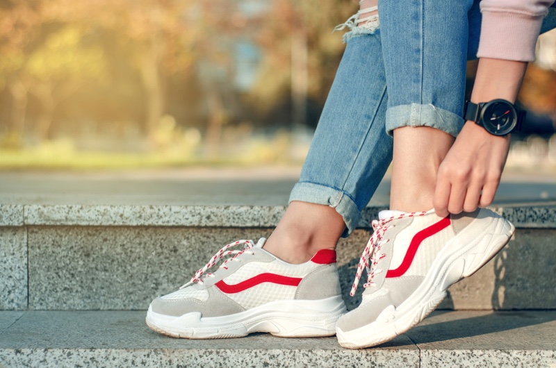 Woman Adjusting Sneakers Watch