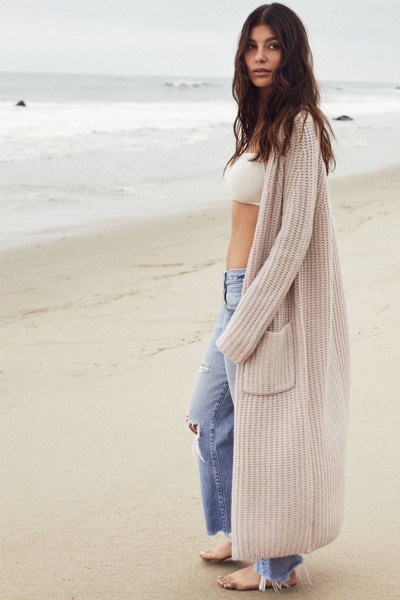 Posing at the beach, Camila Morrone wears Naked Cashmere collaboration