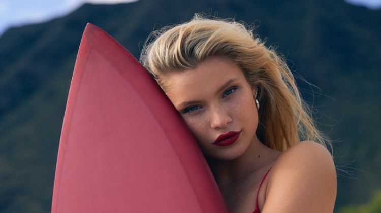 Posing with a surfboard, Josie Canseco fronts Kith x Coco-Cola campaign