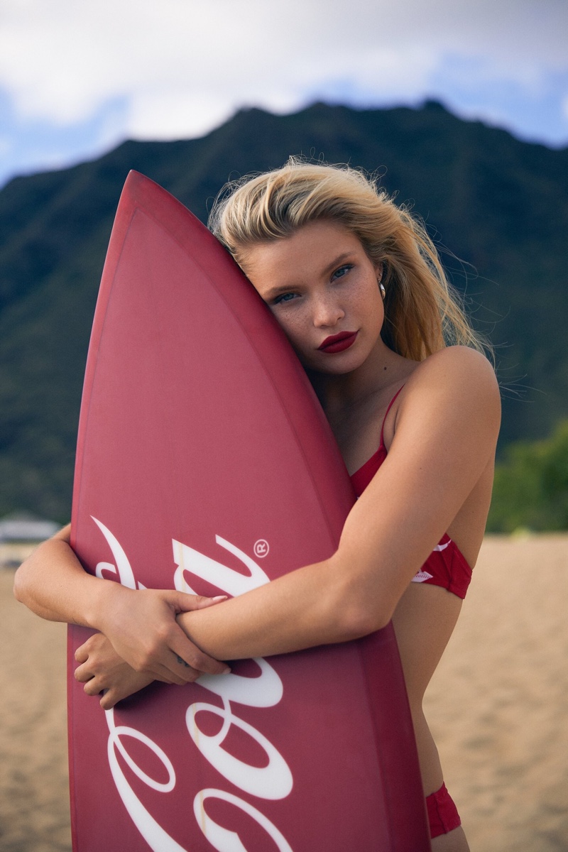 Posing with a surfboard, Josie Canseco fronts Kith x Coca-Cola campaign