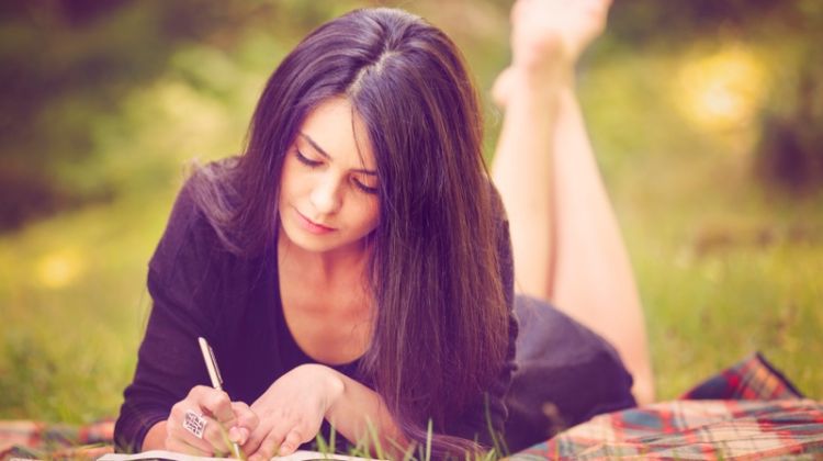 Writing Your First Novel: The 4 Step Process Woman Writing Notebook Outdoors Brunette Dress