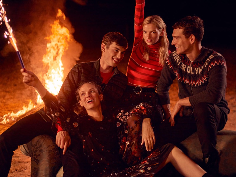 Models pose by a bonfire in Beymen fall-winter 2019 campaign