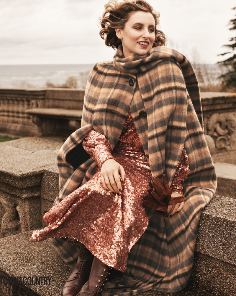 Laura Carmichael poses in Marc Jacobs cape, Sies Marjan dress, Tiffany & Co. earrings and Ariat boots