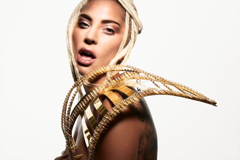 Singer Lady Gaga poses in gold Laurel Dewitt armor skirt 
