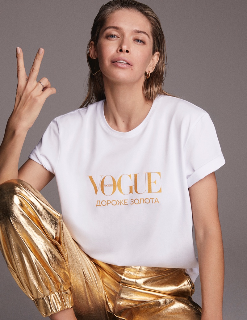 Vera Brezhneva poses in a Vogue shirt with gold pants