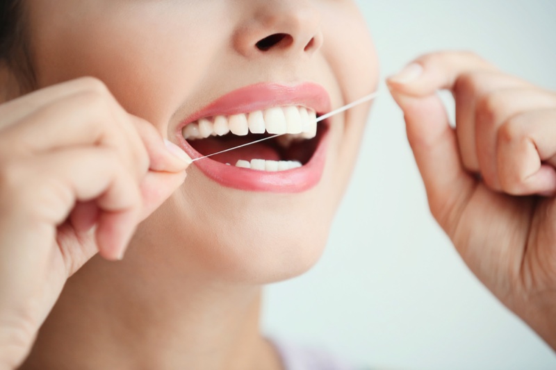 Woman Flossing Teeth Smile