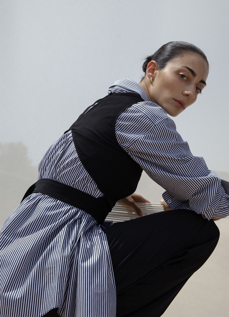 Conie Vallese wears Zara crop top with cut-out detail, striped shirt with asymmetric neckline and wide leg pants with darts