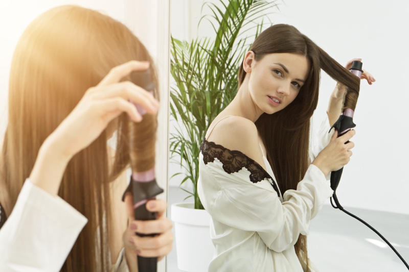 Brunette Model Using Hair Curler Mirror