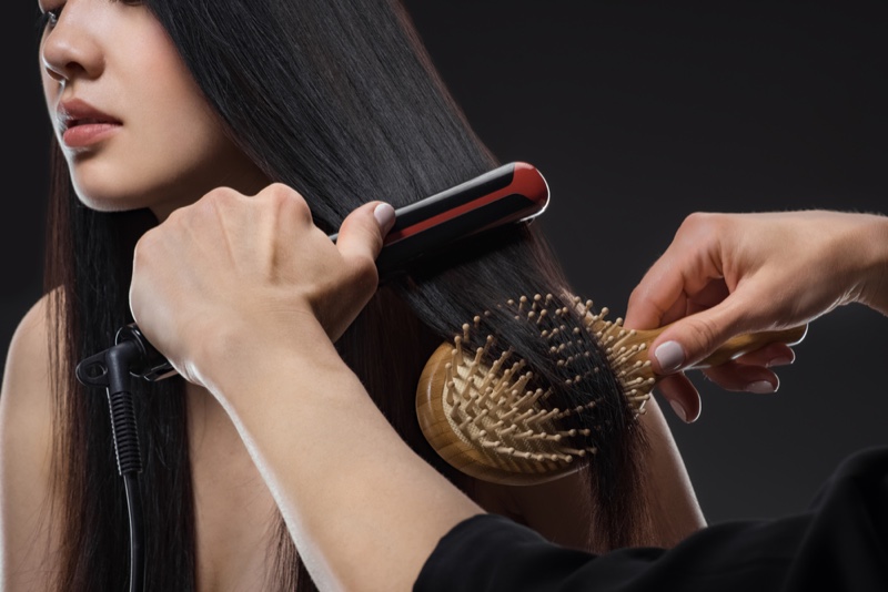 Hairstylist Straightening Brushing Model's Hair