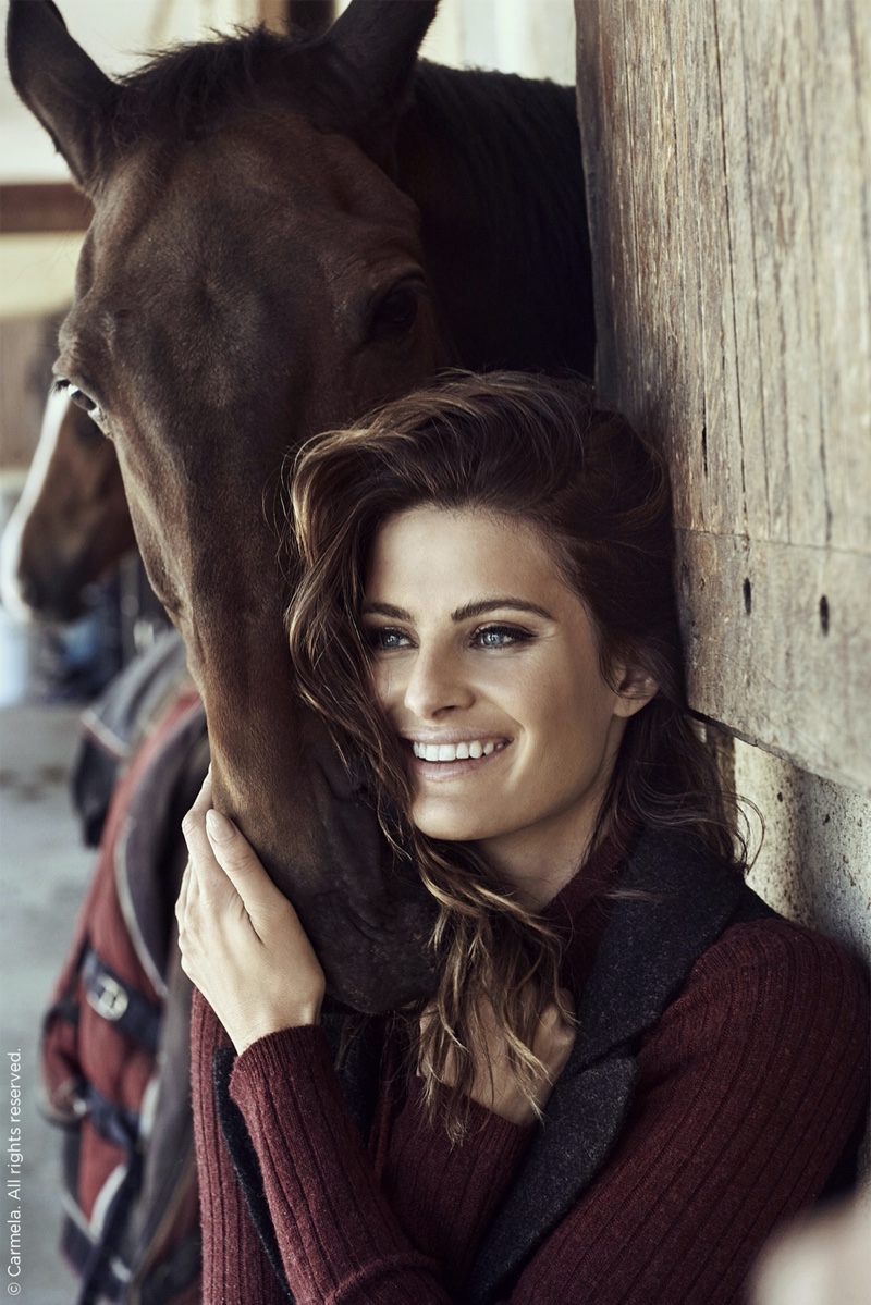All smiles, Isabeli Fontana poses with a horse in Carmela Shoes fall-winter 2019 campaign