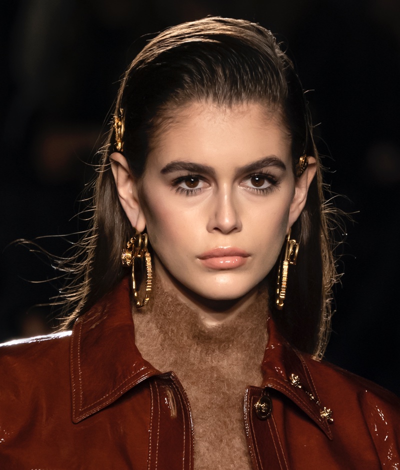 Model Kaia Gerber wears a sleek chestnut brown hair color.