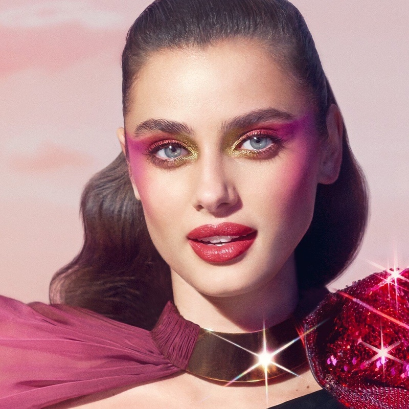 Wearing shades of red, Taylor Hill poses for Lancome Halloween 2019 makeup shoot