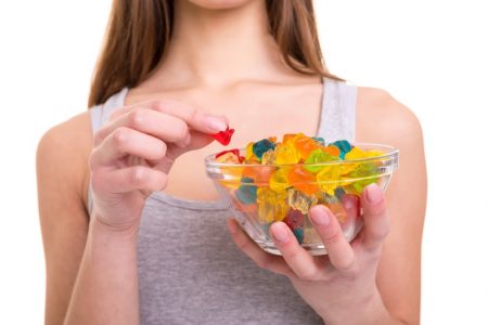 Why CBD Gummies Are Becoming a Globally Well-Known Product Woman Holding Bowl Gummies