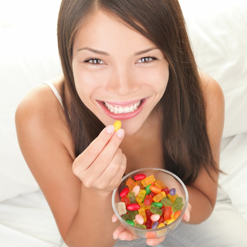Woman Smiling Eating Gummies Candy