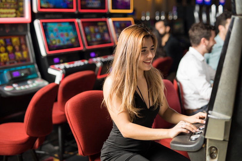 Woman Smiling Playing Slot Machine Casino Black Dress