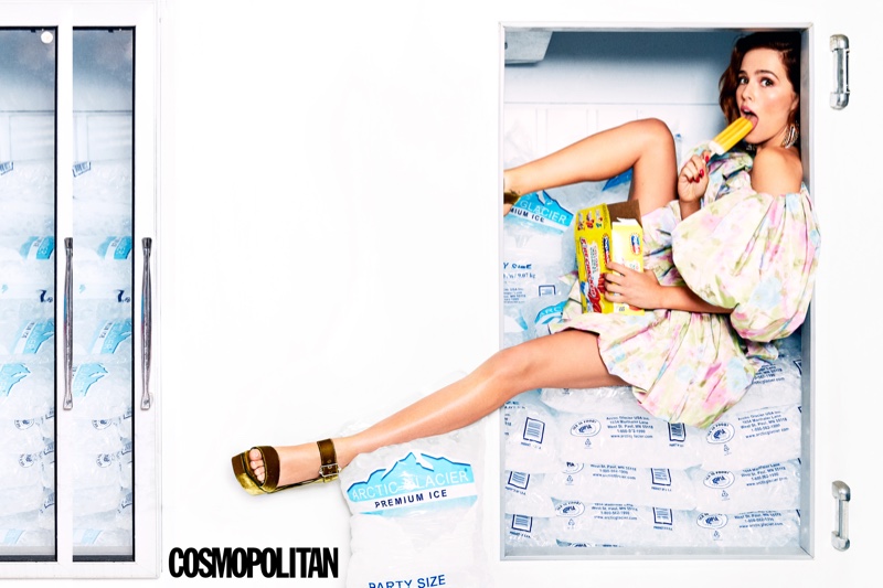 Eating a popsicle, Zoey Deutch wears The Marc Jacobs dress, Jimmy Choo sandals and Area earrings
