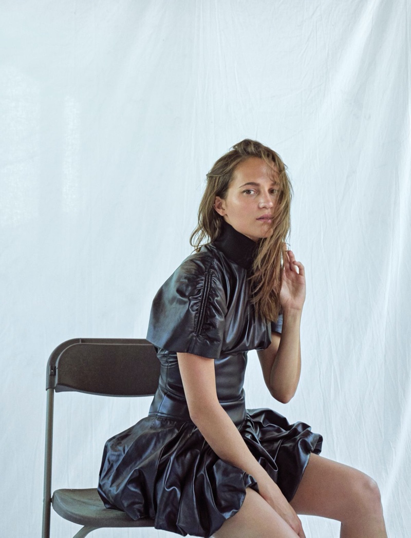 Actress Alicia Vikander poses in black Louis Vuitton dress