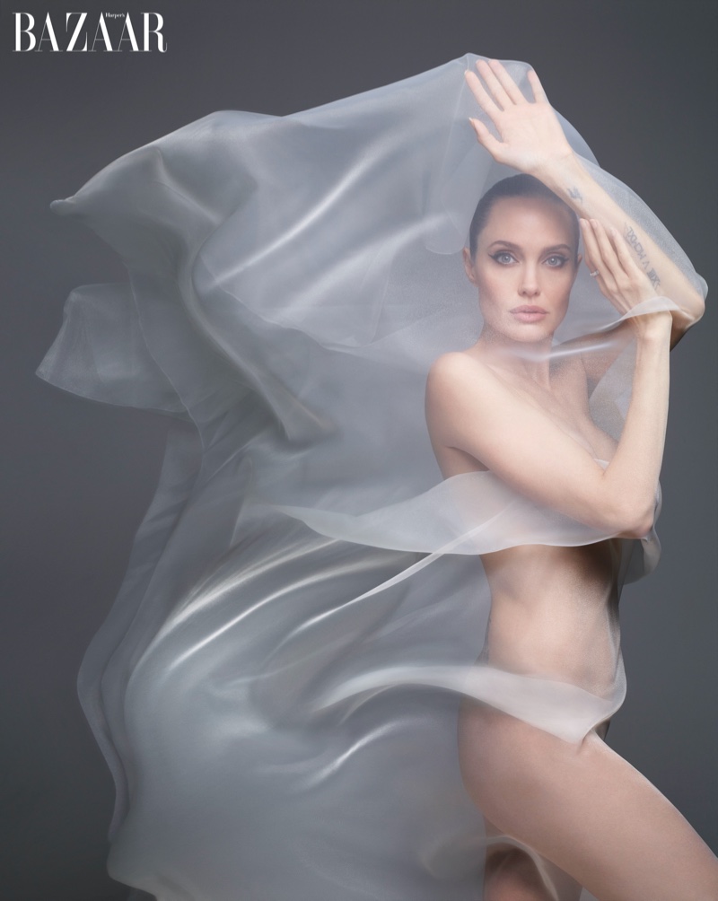 Posing in a sheer veil, Angelina Jolie wears Bulgari Serpenti ring