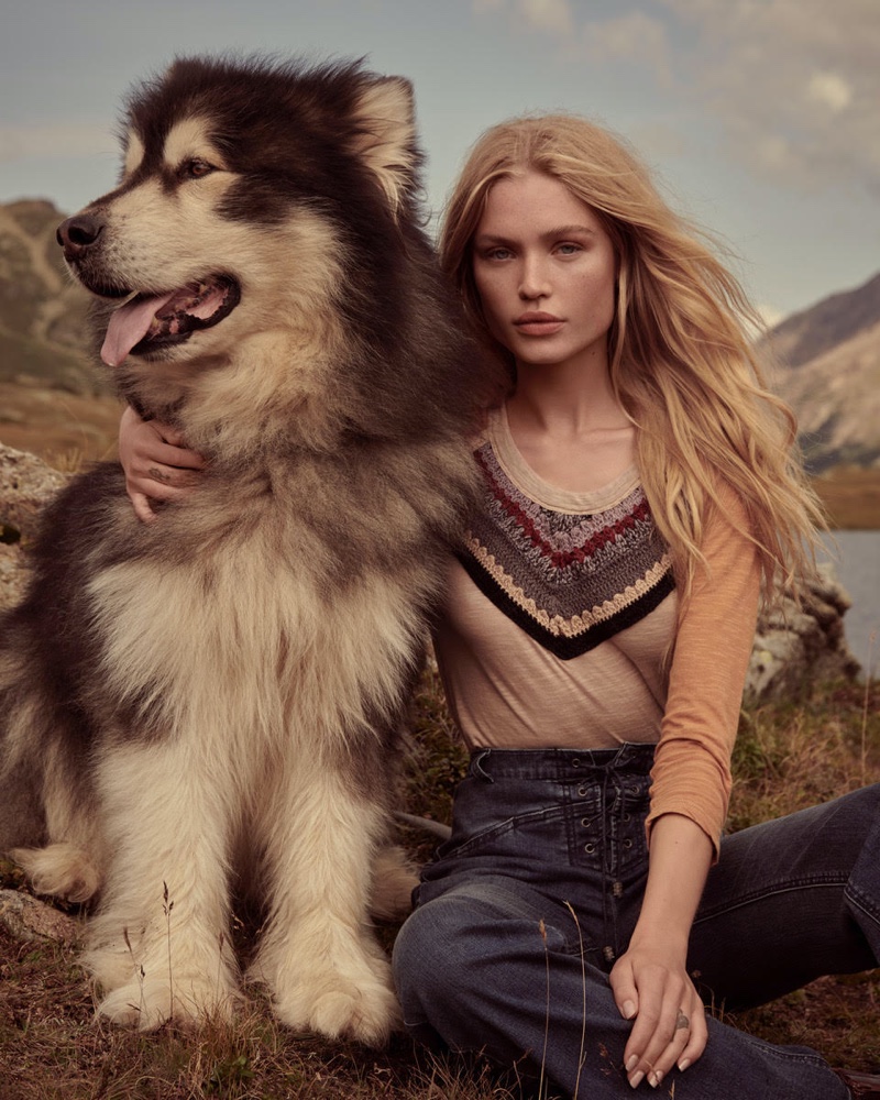 Posing with a dog, Camilla Christensen appears in Free People holiday 2019 campaign