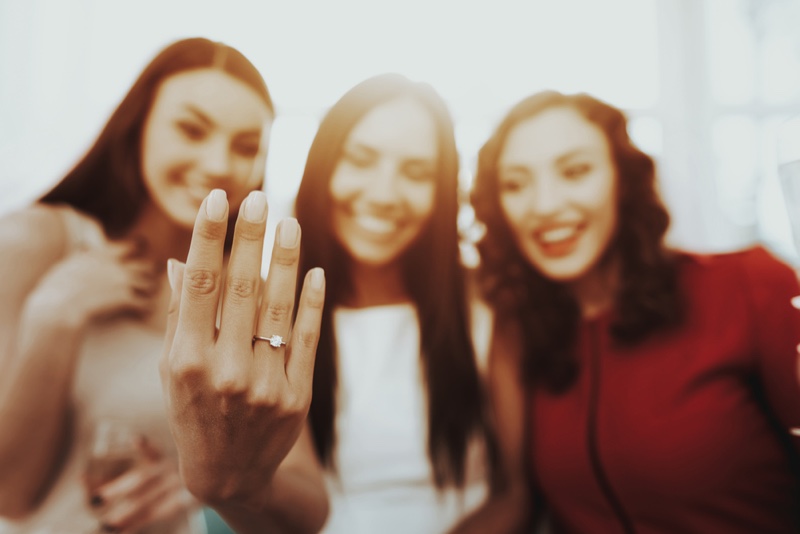 Group Women Admiring Engagement Ring Hand