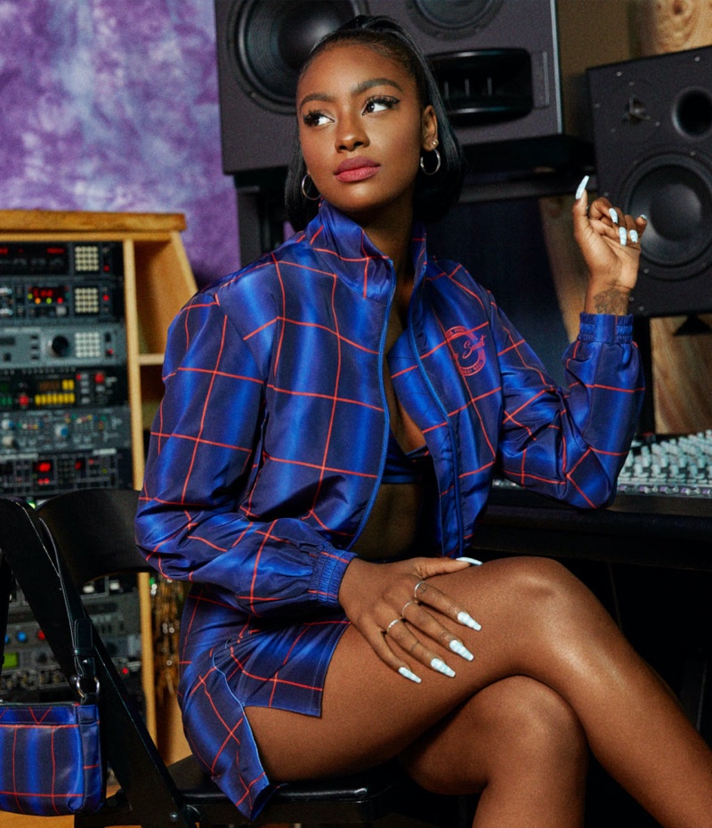 Rocking plaid, Justine Skye poses in H&M clothing collaboration