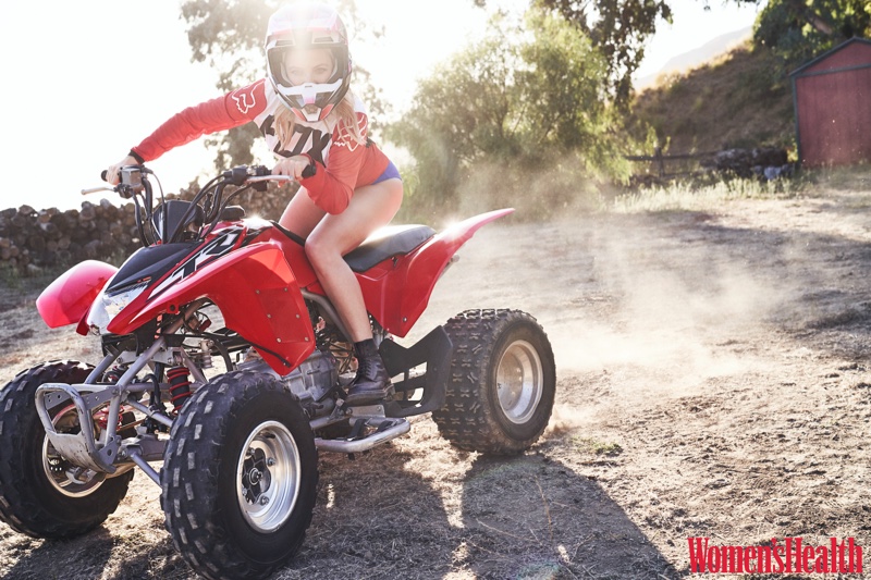 Riding a 4-wheeler, Kate Hudson wears Fox Racing jersey and helmet, Jade Swim bottom and Dr. Martens boots