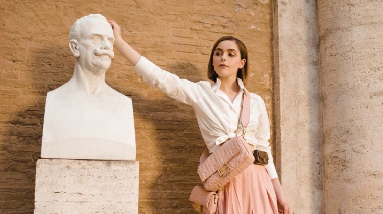 Kiernan Shipka poses in a statue for Fendi #BaguetteFriendsForever campaign