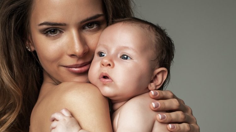 What Is the Budget for Professional Newborn Photography? Mother Model Holding Baby Portrait