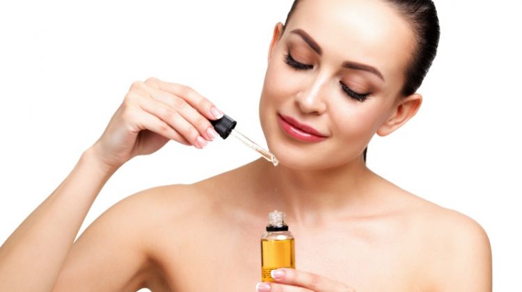 6 Incredible Benefits of CBD Oil Woman Holding Oil Bottle Beauty