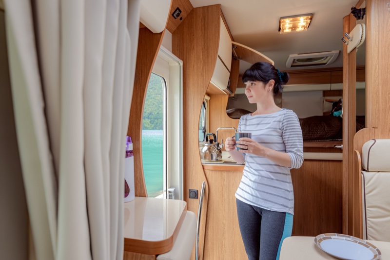 Woman Interior RV Holding Coffee Cup