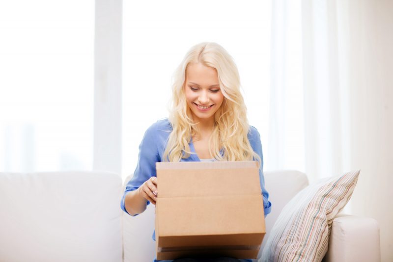 Woman Opening Box Smiling