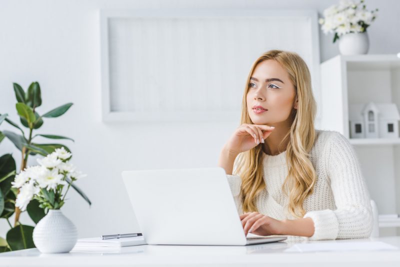 Woman Thinking About Shopping Online