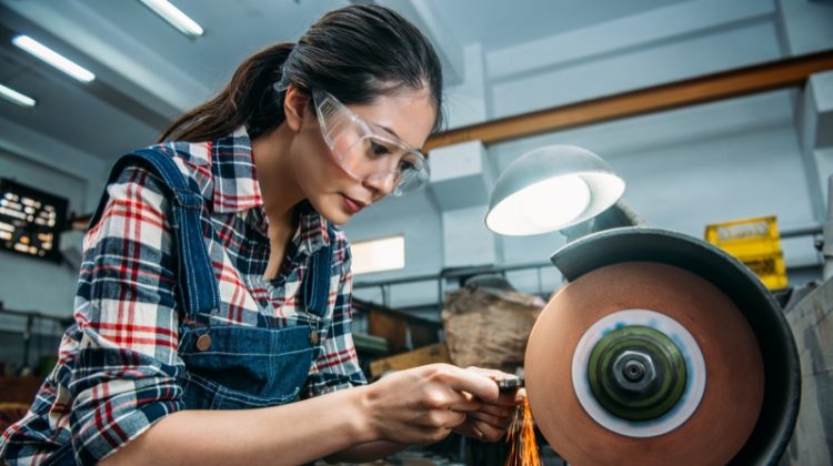How Do You Use a Bench Grinder? Woman Using Grinder Asian Overalls Plaid