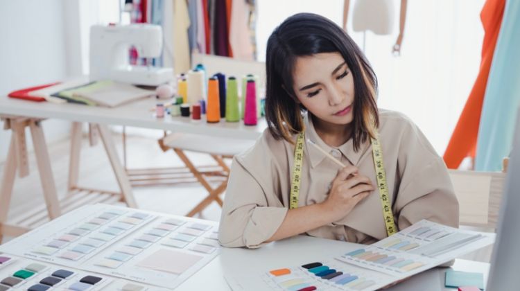 How to Stand Out As a Niche Fashion Brand in 2020? Asian Fashion Designer Looking at Fabric Swatches
