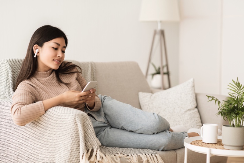 Asian Woman Couch Airpods Lounging Phone