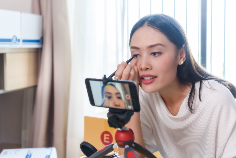 Asian Woman Doing Makeup Camera