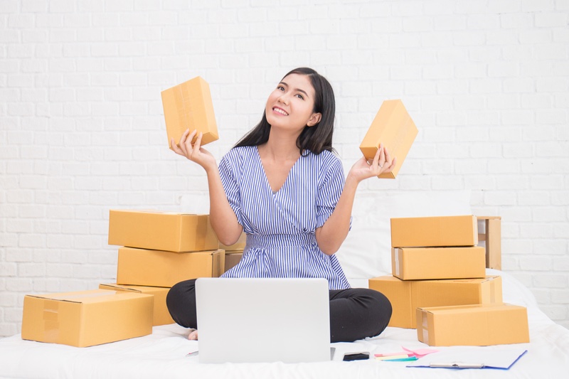 Asian Woman Smiling Boxes Laptop Shopping