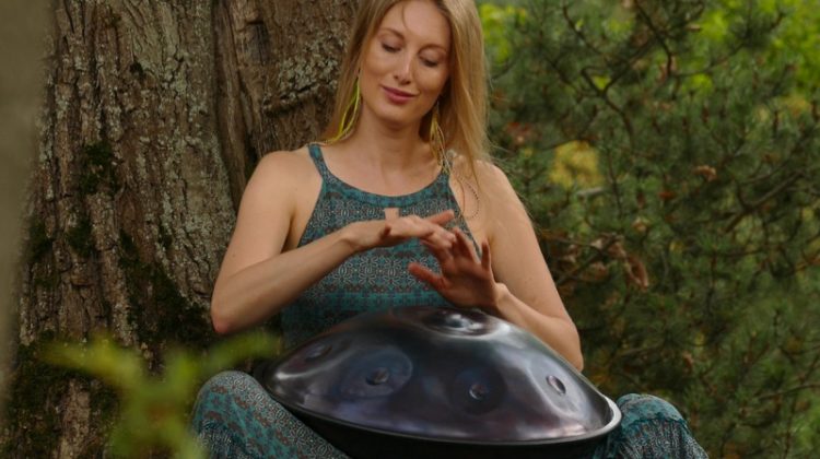 How to Choose a Handpan for Beginners Attractive Woman Outside Playing Handpan