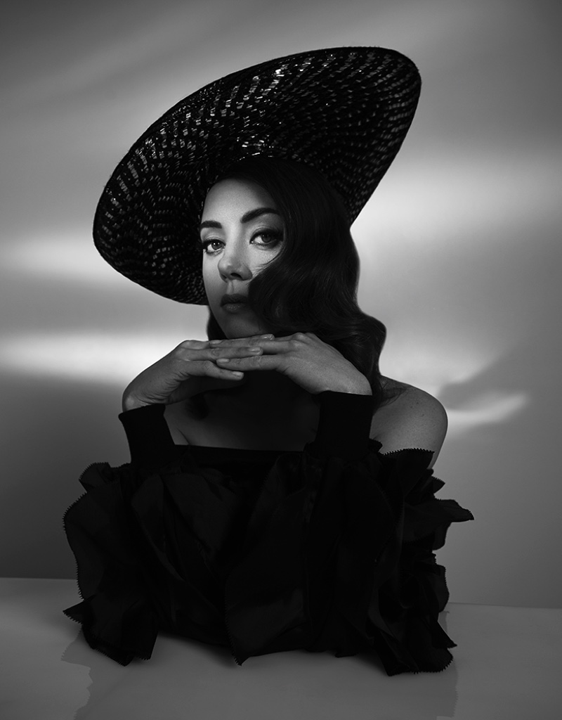 Captured in black and white, Aubrey Plaza wears Anna Kiki top with vintage Dior hat