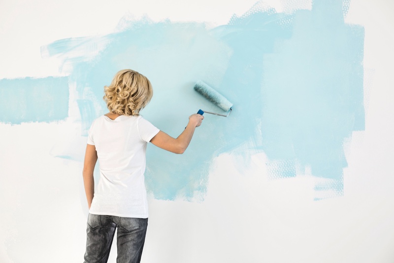 Blonde Woman Painting Wall Light Blue