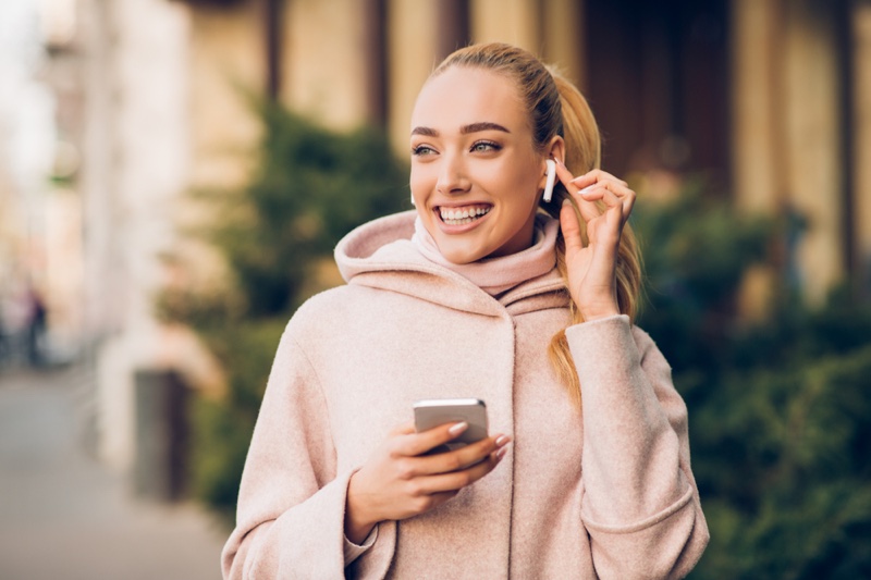 Blonde Woman Smiling Airpods Phone Pink Jacket