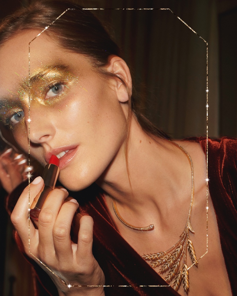 Putting on lipstick, Josephine le Tutour appears in Boucheron Holiday 2019 campaign