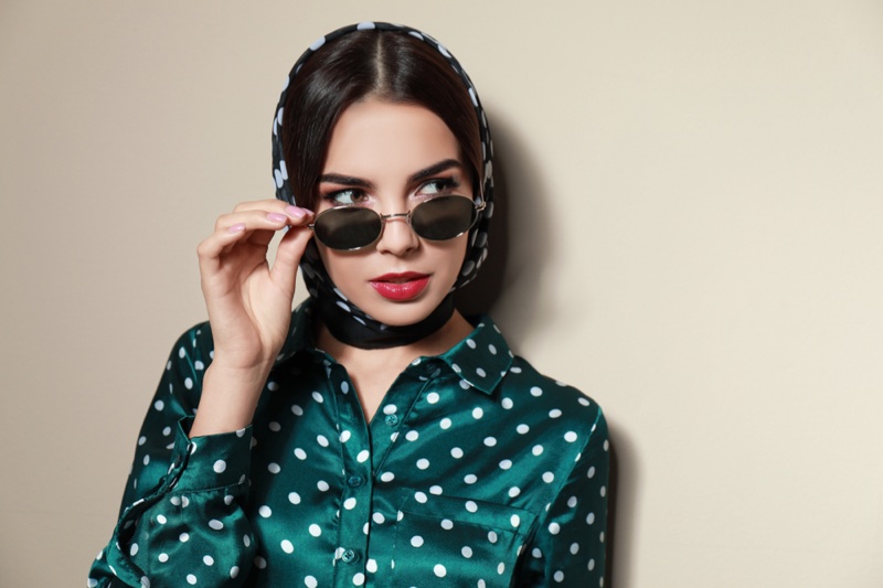 Modèle brune cheveux rétro maquillage chemise à pois tête foulard lunettes de soleil