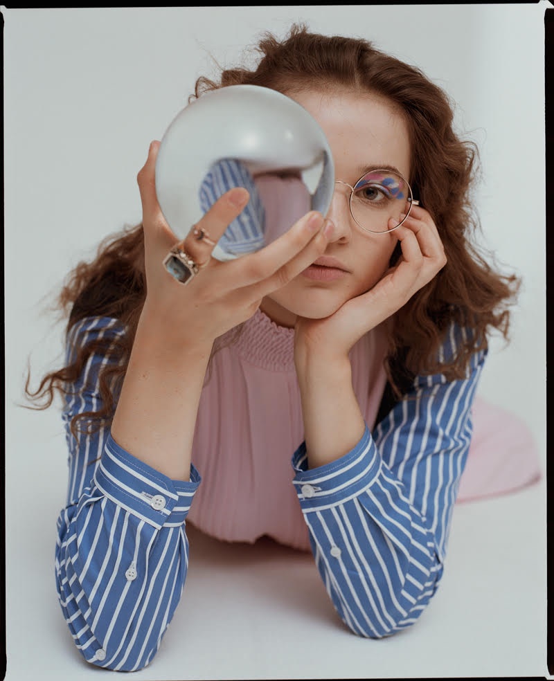 Posing with an orb, Lisa Vicari wears a fashionable look