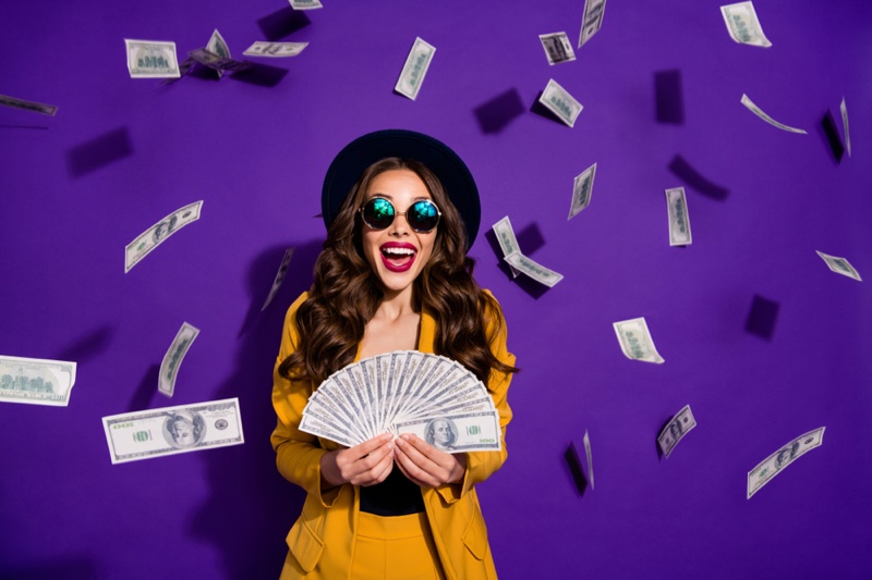 Smiling Woman Yellow Pant Suit Money Hat