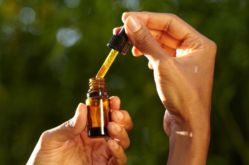Woman Holding CBD Oil
