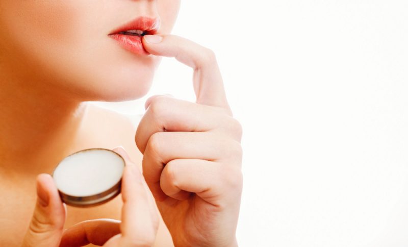 Woman Putting Vaseline on Lips
