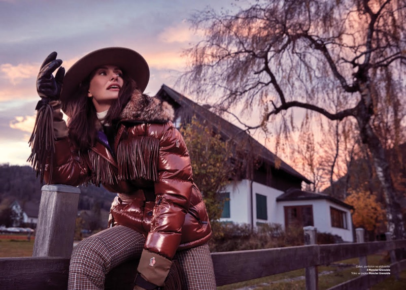 Posing outdoors, Yasemin Ozilhan wears puffer jacket and plaid trousers from Moncler Grenoble