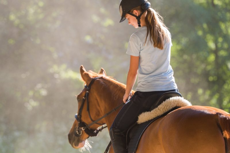 Young Girl Riding Horse